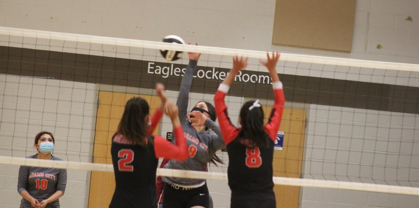 Adams City’s Michelle Cazares attacks the ball at the net against the defense of Brighton’s Evelyn Udezue (2) and Keilani Infante (8) April 15 in Commerce City. The Eagles’ Cruz Galaz is in the background.